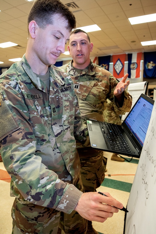 U.S. Army Capts. Joshua Witherell, 368th Financial Management Support Unit Detachment 2 commander, left, and Jared Viernes, 368th Financial Management Support Unit commander, work through a problem during an Army Reserve Company Leader Development Course at Fort McCoy, Wisconsin, June 20, 2019. CLDC teaches officers and noncommissioned officers leadership fundamentals and gives them tools to maximize training and effectiveness.