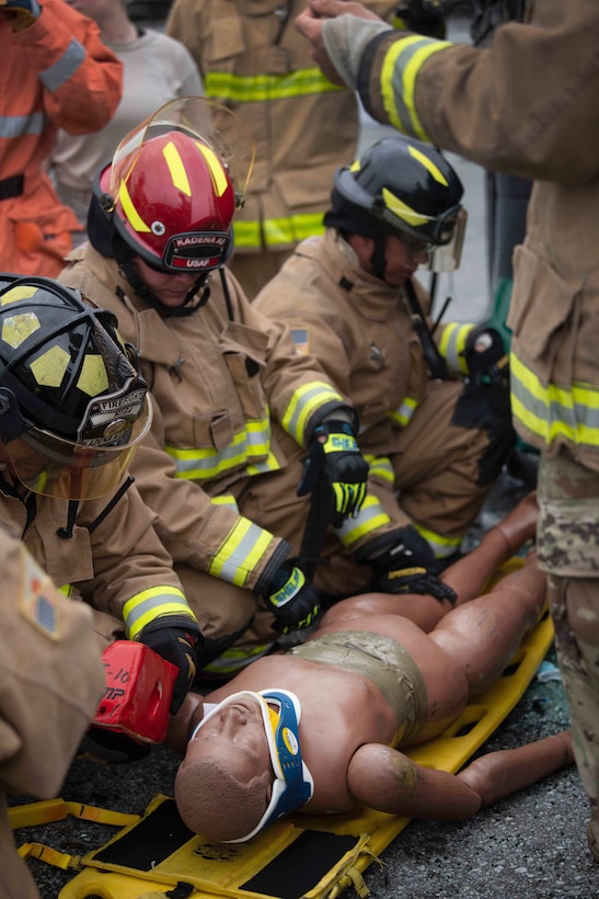 U.S. Air Force Airmen assigned to the 18th Civil Engineer Squadron fire and emergency services flight train with a member of the Japan Air Self Defense Force as part of a bilateral exchange at Kadena Air Base, Japan, June 19, 2019.