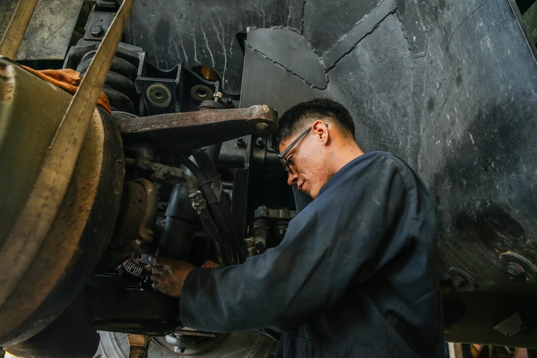 U.S. Marine Corps Cpl. Reuben J. Pinargote performs maintenance on a Medium Tactical Vehicle Replacement with a Maintenance Support Team on Camp Foster, Okinawa, Japan, June 18, 2019.  The purpose of an MST is to send a team of Marines from outside units to temporarily provide support to units who are in need of manpower in specific Military Occupational Specialties. Pinagrote, a native of Columbia, Maryland, is an automotive maintenance technician with Combat Logistics Regiment 35, and was temporarily assigned to an MST to assist Marine Wing Support Squadron 172. (U.S. Marine Corps photo by Sgt. Hailey D. Clay)