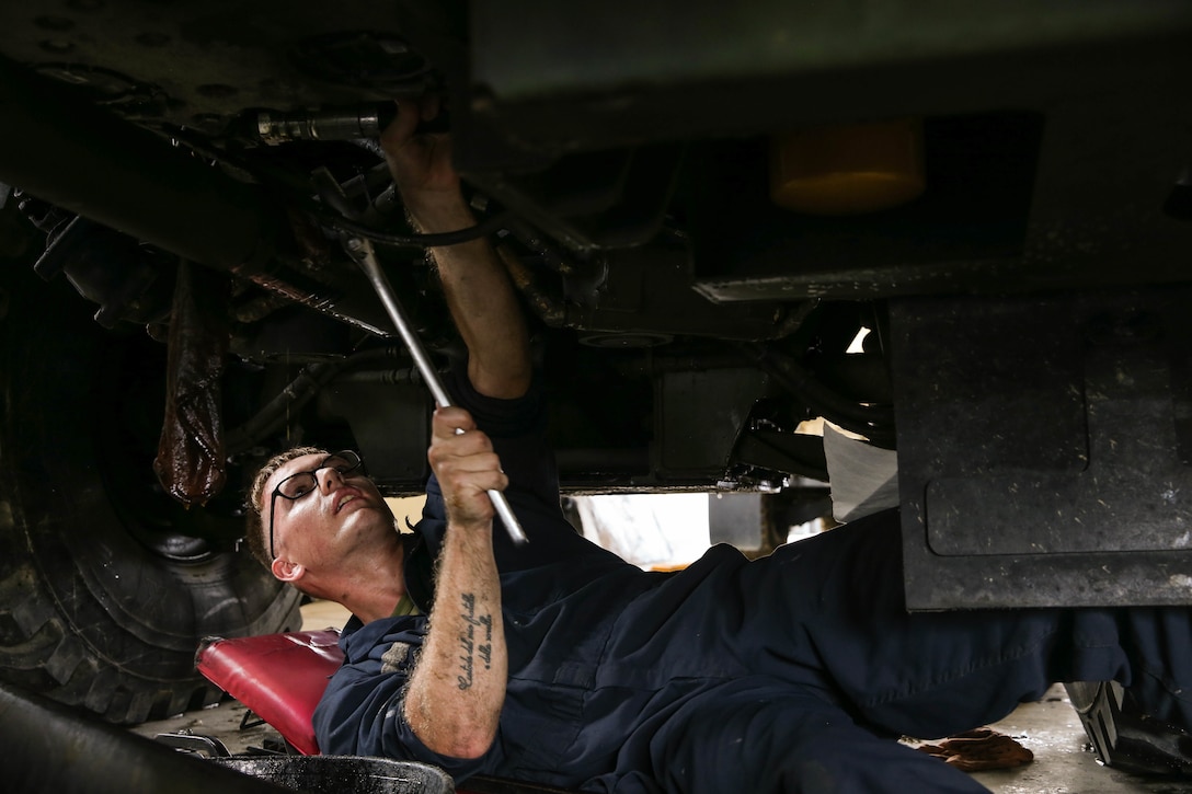 U.S. Marine Corps Cpl. Collin Lourie performs maintenance on a Medium Tactical Vehicle Replacement as part of a Maintenance Support Team on Camp Foster, Okinawa, Japan, June 18, 2019.  The purpose of an MST is to send a team of Marines from outside units to temporarily provide support to units who are in need of manpower in specific Military Occupational Specialties. Lourie, a native of Cambridge, New York, is an automotive maintenance technician with Combat Logistics Regiment 35, and was temporarily assigned to an MST to assist Marine Wing Support Squadron 172. (U.S. Marine Corps photo by Sgt. Hailey D. Clay)