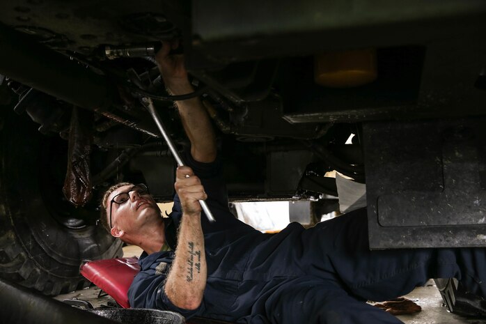 U.S. Marine Corps Cpl. Collin Lourie performs maintenance on a Medium Tactical Vehicle Replacement as part of a Maintenance Support Team on Camp Foster, Okinawa, Japan, June 18, 2019.  The purpose of an MST is to send a team of Marines from outside units to temporarily provide support to units who are in need of manpower in specific Military Occupational Specialties. Lourie, a native of Cambridge, New York, is an automotive maintenance technician with Combat Logistics Regiment 35, and was temporarily assigned to an MST to assist Marine Wing Support Squadron 172. (U.S. Marine Corps photo by Sgt. Hailey D. Clay)