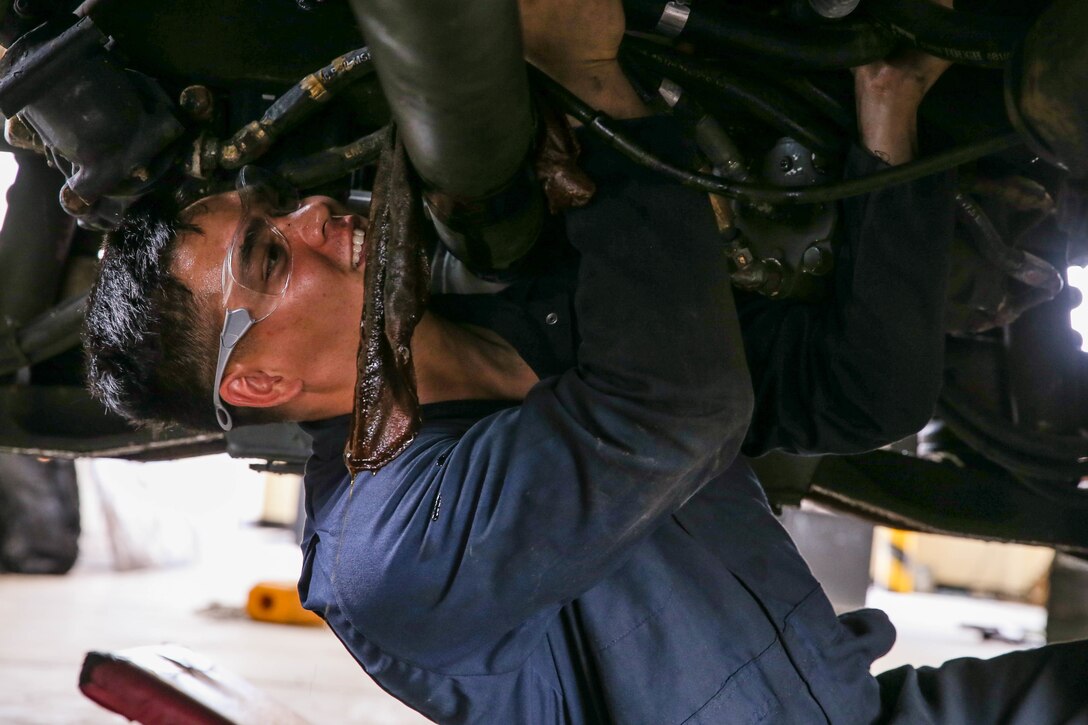 U.S. Marine Corps Cpl. Sebastian Crossley performs maintenance on a Medium Tactical Vehicle Replacement with a Maintenance Support Team on Camp Foster, Okinawa, Japan, June 18, 2019.  The purpose of an MST is to send a team of Marines from outside units to temporarily provide support to units who are in need of manpower in specific Military Occupational Specialties. Crossley, a native of Queenstown, Maryland, is an automotive maintenance technician with Combat Logistics Regiment 35, and was temporarily assigned to an MST to assist Marine Wing Support Squadron 172. (U.S. Marine Corps photo by Sgt. Hailey D. Clay)