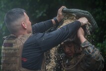 U.S. Marine Corps Marital Arts Program Instructor Trainer Staff Sgt. Cesar Menendezezlozano, left, awards Cpl. Abimael Reyes-Aguilar, right, his Marine Corps Martial Arts Program Instructor tab at Camp Hansen, Okinawa, Japan, June 20, 2019. Menendezezlozano, a manpower chief with Combat Logistics Regiment 35, 3rd Marine Logistics Group, held the instructor course to create MCMAP force multipliers not only for the MLG but for the entire III Marine Expeditionary Force. Menendezezlozano is a native of Chicago, Illinois. Reyes-Aguilar, a food service specialist with Food Service Company, Combat Logistics Regiment 37, 3rd MLG, is a native of Gardena, California. (U.S. Marine Corps photo by Lance Cpl. Isaiah Campbell)