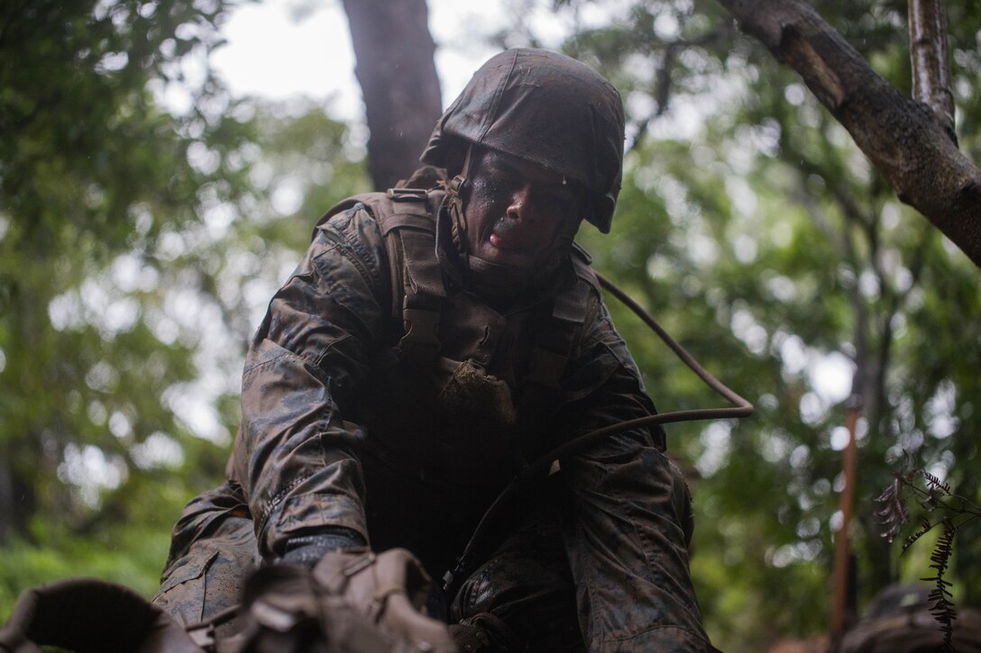 U.S. Marine Corps Cpl. Yousaf Sheikh assists another student during a Marine Corps Martial Arts Program Instructor Course at Camp Hansen, Okinawa, Japan, June 20, 2019. Sheikh, with Headquarters Company, Combat Logistics Regiment 35, 3rd Marine Logistics Group, participated in the instructor course in order to become a MCMAP force multiplier. Sheikh is a native of Brooklyn, New York. (U.S. Marine Corps photo by Lance Cpl. Isaiah Campbell)