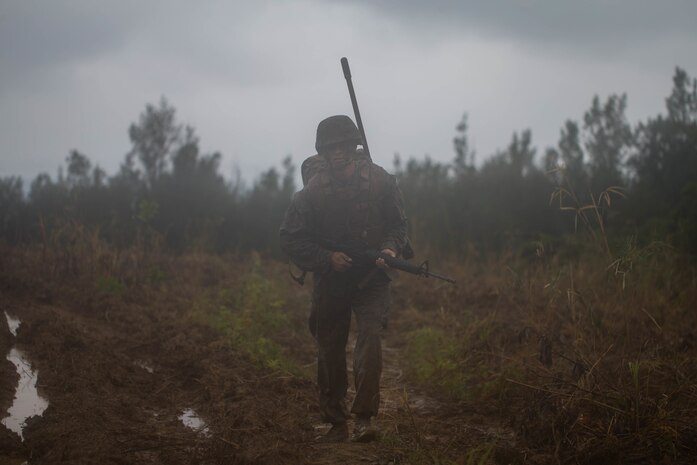 U.S. Marine Corps Cpl. Sterling Long endures the culminating event during a Marine Corps Martial Arts Program Instructor Course at Camp Hansen, Okinawa, Japan, June 20, 2019. Long, with Combat Logistics Regiment 37, 3rd Marine Logistics Group, participated in the instructor course in order to become a MCMAP force multiplier. Long is a native of Waco, Texas. (U.S. Marine Corps photo by Lance Cpl. Isaiah Campbell)
