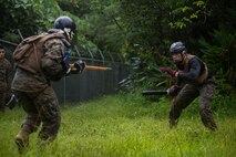 U.S. Marines participate in the culminating event during a Marine Corps Martial Arts Program Instructor Course at Camp Hansen, Okinawa, Japan, June 20, 2019. For the culminating event the Marines ran an endurance course, as well as conducted several stand-up and ground fighting scenarios in order to push their bodies beyond their anticipated physical limits. (U.S. Marine Corps photo by Lance Cpl. Isaiah Campbell)