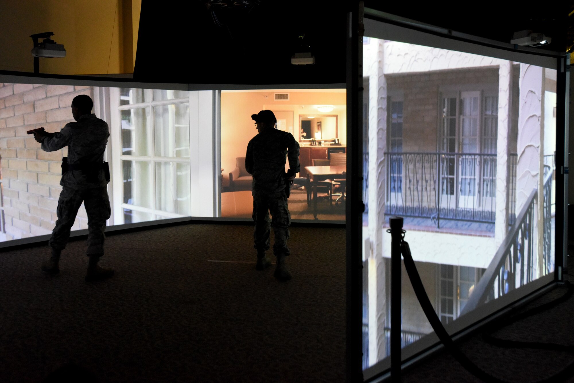 Members of the North Carolina (NC) and Louisiana (L) Air National Guard (ANG) conduct use of force and tactical situational practice in a Fire Arms Training Simulator simulator June 12, 2019 at the 176th Security Forces Squadron in Anchorage, AK. The 145th Security Forces and 263rd Combat Communications Squadrons with the NCANG, and the 159th Security Forces Squadron with the LANG travel to Joint Base Elmendorf-Richardson to train on various tactical and strategic law enforcement procedures during annual training.