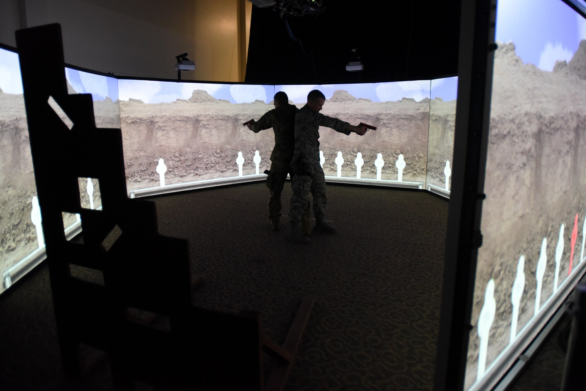 Members of the North Carolina (NC) and Louisiana (L) Air National Guard (ANG) conduct use of force and tactical situational practice in a Fire Arms Training Simulator simulator June 12, 2019 at the 176th Security Forces Squadron in Anchorage, AK. The 145th Security Forces and 263rd Combat Communications Squadrons with the NCANG, and the 159th Security Forces Squadron with the LANG travel to Joint Base Elmendorf-Richardson to train on various tactical and strategic law enforcement procedures during annual training.