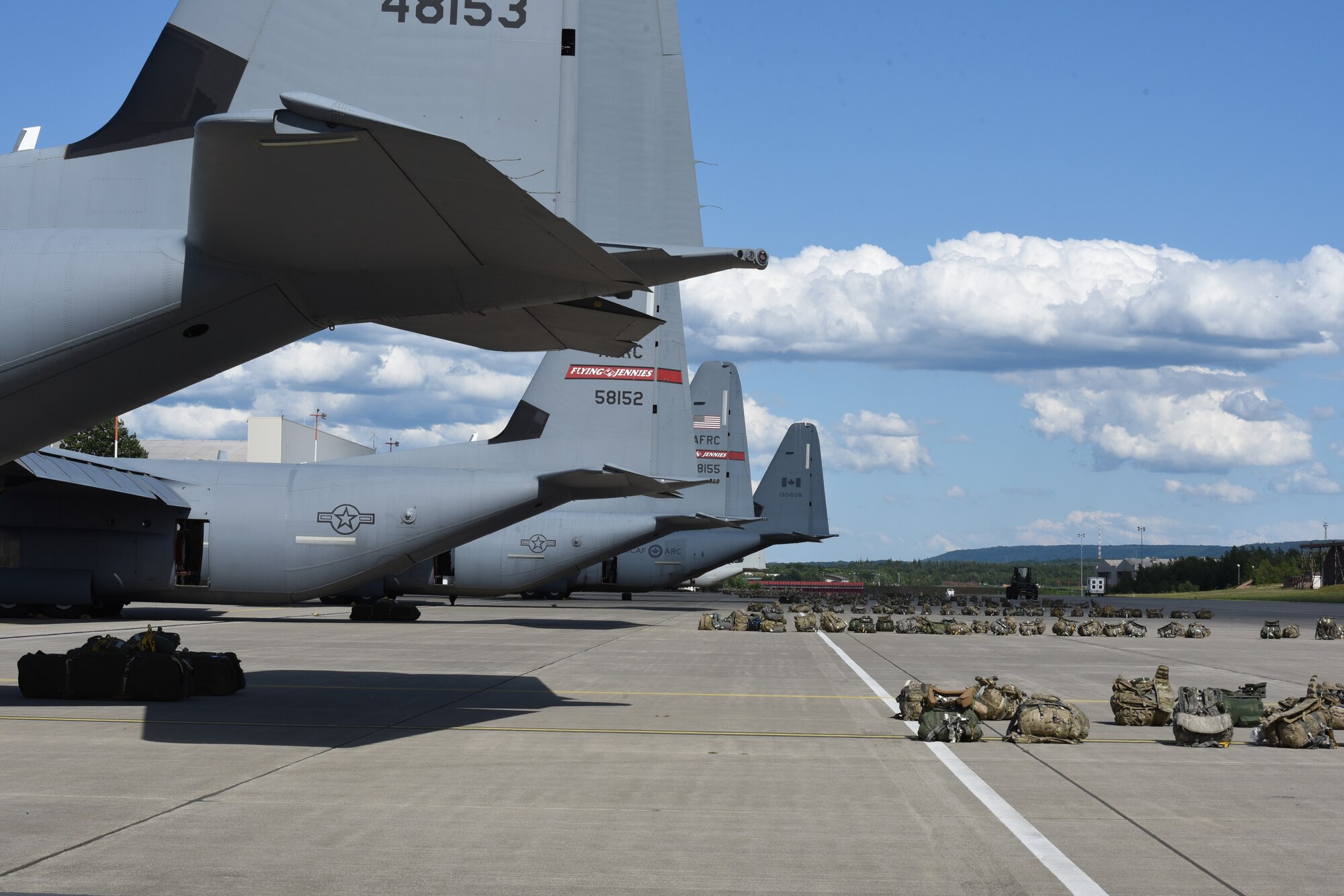 Army ruck sacks sit behind the aircraft for the first airdrop of exercise Swift Response 19, June 13, 2019. The exercise is one of the premier military crisis response training events featuring high readiness airborne forces from eight NATO nations. Activities include intermediate staging base operations, multiple airborne operations, and several air assault operations. The Swift Response exercises have had great success in creating a foundation for the strong relationships we share with several European allies and partners today. (U.S. Air Force photo by Master Sgt. Jessica Kendziorek)