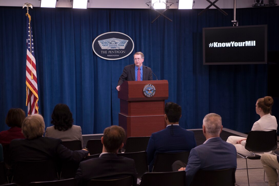 A man speaks from behind a podium.