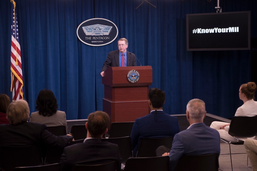 A man speaks from behind a podium.