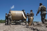 U.S. Marines with Bulk Fuel Company, 8th Engineer Support Battalion, 2nd Marine Logistics Group, utilize a hose-reel system to lay down a fuel line during a Bulk Fuel exercise at Camp Lejeune, N.C., June 19, 2019. The Marines with 8th ESB ran fuel lines, patrolled the fuel sites and provided all around security to remain proficient in fueling support operations. (U.S. Marine Corps photo by Lance Cpl. Adaezia L. Chavez)