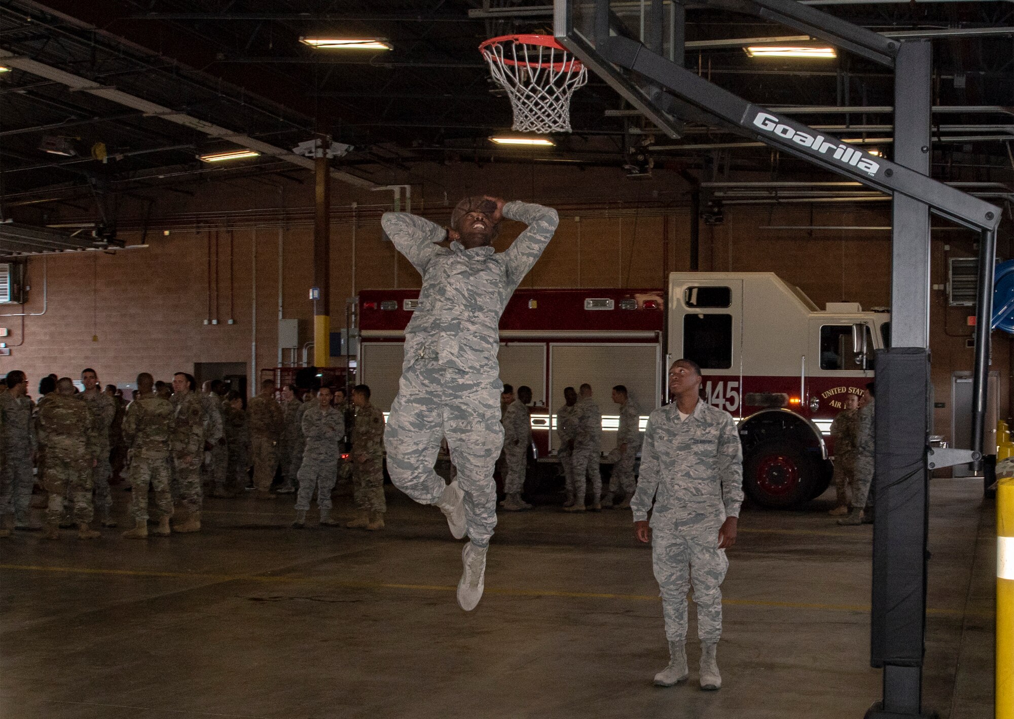 U.S. Air Force Airmen 1st Class Cody Shelton, left, and Rico Polk, 60th Civil Engineer Squadron electrical system technicians, play one-on-one basketball June 24, 2019, at Travis Air Force Base, California. The Airmen engaged in an impromptu basketball game prior to a squadron group photo. The Air Force Fitness Program’s goal is to motivate Airmen to participate in a year-round physical conditioning program that emphasizes total fitness, including proper aerobic conditioning, strength and flexibility training and healthy eating. Health benefits from an active lifestyle increases productivity, optimizes health and decreases absenteeism while maintaining a higher level of readiness. (U.S. Air Force photo by Heide Couch)