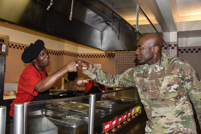 Gosnel James, grill cook at the Dish dining facility, prepares a hamburger for a customer during lunch time at Schriever Air Force Base, Colorado, June 14, 2019. Caribbean-American Heritage month is celebrated during June, recognizing the significance of Caribbean people and their heritage in the culture and history of the United States. (U.S. Air Force photo by 2nd Lt. Idalí Beltré Acevedo)