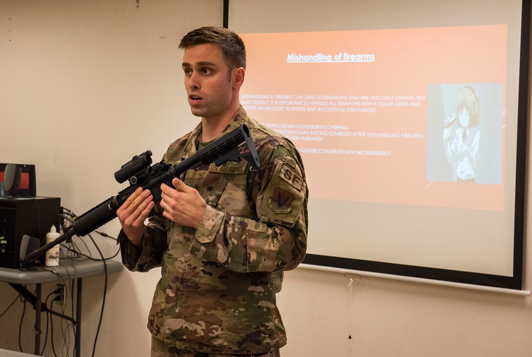 Staff Sgt. Brandon Nendel, 23d Security Forces Squadron Combat Arms Training and Maintenance instructor, demonstrates the proper handling techniques for a firearm during a weapons safety class, June 18, 2019, at Moody Air Force Base, Ga. Weapons safety courses teach safe habits with firearms that ensure your own safety and the safety of those around you. (U.S. Air Force photo by Airman Azaria Foster)
