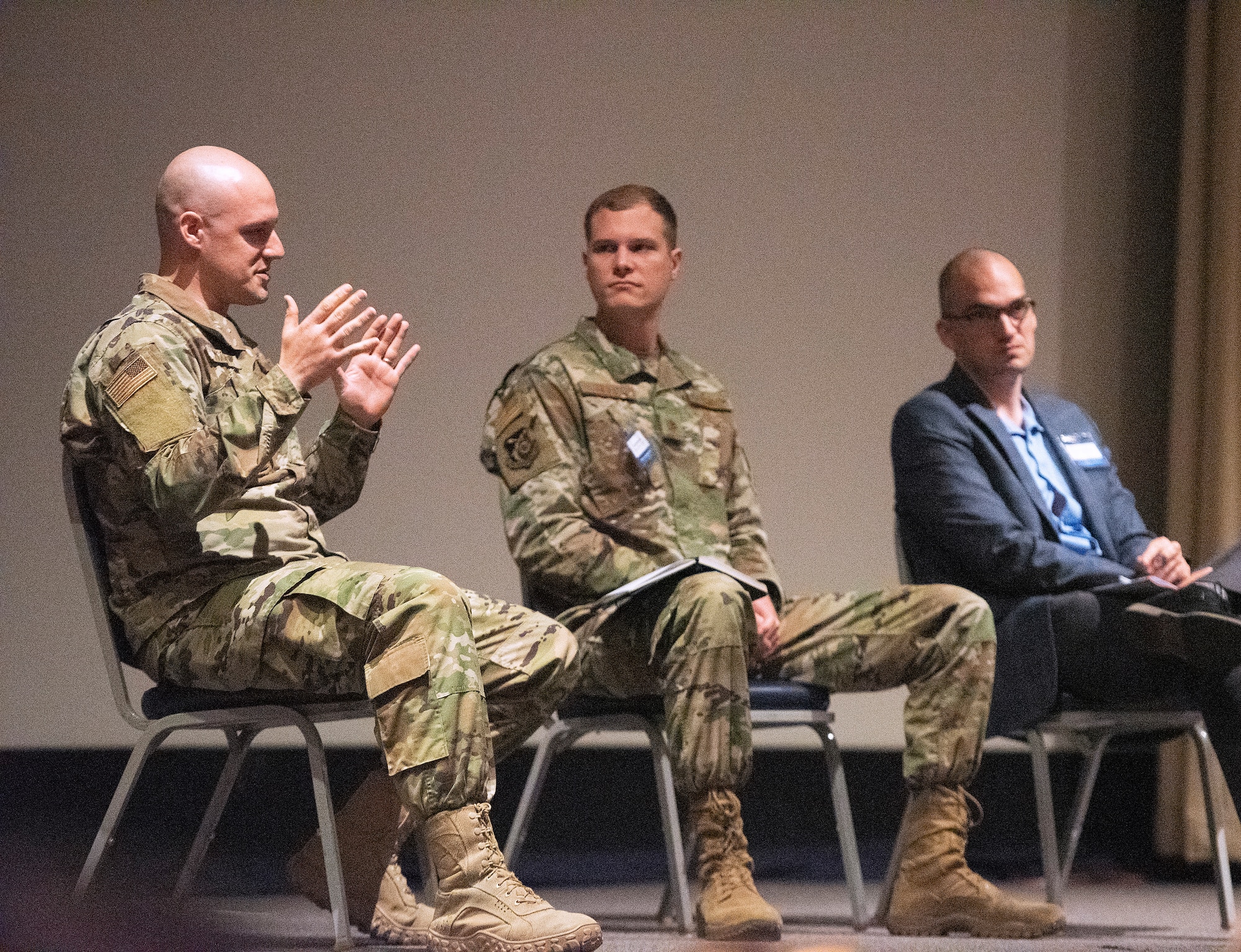 Maj. Zachary McCarty (left), Maj. Matthew Getts and Dr. Michael Tanner discuss a variety of topics during the Implementing Acquisition Transformation panel.(U.S. Air Force photo by R.J. Oriez)
