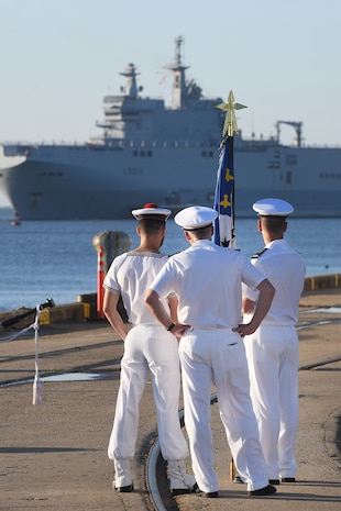 Members of the Marine Nationale (French Navy) watch Landing Helicopter Dock Tonnerre move toward the Columbus Terminal Port as part of a deployment stopover June 21, 2019, in Charleston, S.C. U.S. Navy Cmdr. Patrick Sutton, Naval Support Activity Charleston executive officer and 628th Mission Support Group deputy commander, spoke with leaders of LHD Tonnerre to ensure the crew received support during their stay in Charleston. Engagements such as this provide opportunities to strengthen partnerships between allies.