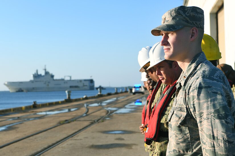 U.S. Air Force 2nd Lt. Jonathon Mogan, assigned to the 437th Aerial Port Squadron, watches the Marine Nationale (French Navy) Landing Helicopter Dock Tonnerre move toward the Charleston Terminal Port as part of a deployment stopover June 21, 2019, in Charleston, S.C. U.S. Navy Cmdr. Patrick Sutton, Naval Support Activity Charleston executive officer and 628th Mission Support Group deputy commander, spoke with leaders of LHD Tonnerre to ensure the crew received support during their stay in Charleston. Engagements such as this provide opportunities to strengthen partnerships between allies.