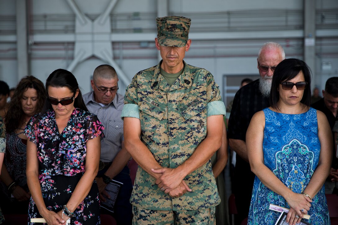 U.S. Marine Corps Sgt.Maj. Brian D. Olea, outgoing Sergeant Major, bows his head for the Chaplain’s invocation during the Marine Operational Test and Evaluation Squadron One Relief and Appointment Ceremony at Marine Corps Air Station Yuma Ariz., June 6, 2019. The Relief and Appointment ceremony is an honored product of the rich heritage of Naval tradition. The heart of the ceremony is the passing of the NCO Sword by the Activity Commander from the outgoing Sergeant Major to the new Sergeant Major which signifies the transfer of responsibility, accountability, and authority, from one individual to another. (U.S. Marine Corps photo by Cpl. Joel Soriano)
