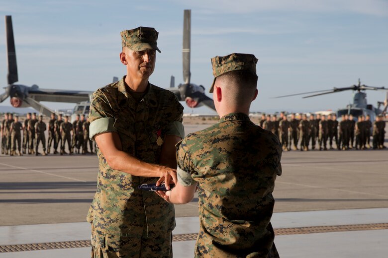 U.S. Marine Corps Sgt.Maj. Brian D. Olea, the outgoing Sergeant Major, receives old glory during the Marine Operational Test and Evaluation Squadron (VMX) one Relief and Appointment Ceremony at Marine Corps Air Station Yuma Ariz., June 6, 2019. Sgt.Maj. Olea served with VMX-1 honorably for three years, ensuring that Marines assigned to the squadron performed their duties while continuously building unit morale.  (U.S. Marine Corps photo by Cpl. Joel Soriano)