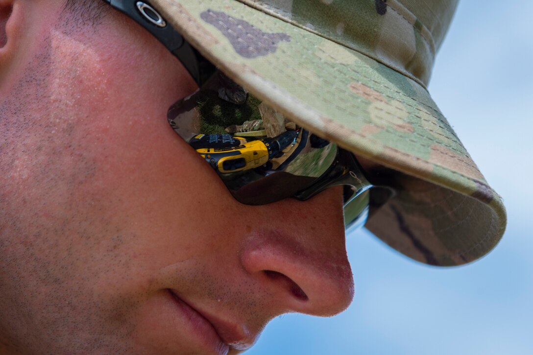 Senior Airman Wayland Bailey, 23d Civil Engineer Squadron water and fuels systems maintainer, uses a drill, June 2, 2019, near Sainte-Mère-Église, France. The engineers provided structural support for the Commemoration of D-Day 75 by repairing and building bridges that were used to access hard-to-reach areas of a parachute drop zone. As part of the commemoration, parachutists from across the Department of Defense performed the same jumps their predecessors did on D-Day. (U.S. Air Force photo by Airman 1st Class Hayden Legg)