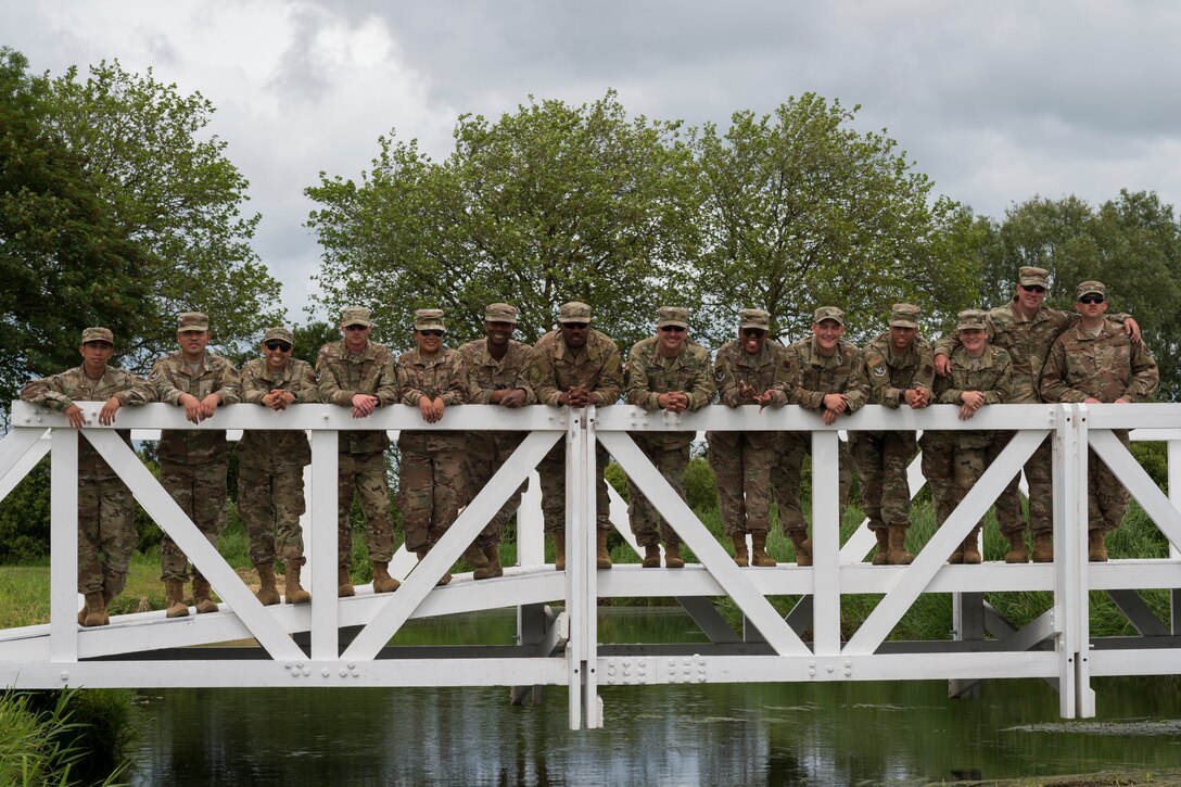 Airmen from the 23d Civil Engineer Squadron pose for a photo, June 5, 2019, in Sainte-Mère-Église, France. The engineers provided structural support for the Commemoration of D-Day 75 by repairing and building bridges that were used to access hard-to-reach areas of a parachute drop zone. As part of the commemoration, parachutists from across the Department of Defense performed the same jumps their predecessors did on D-Day. (U.S. Air Force photo by Airman 1st Class Hayden Legg)