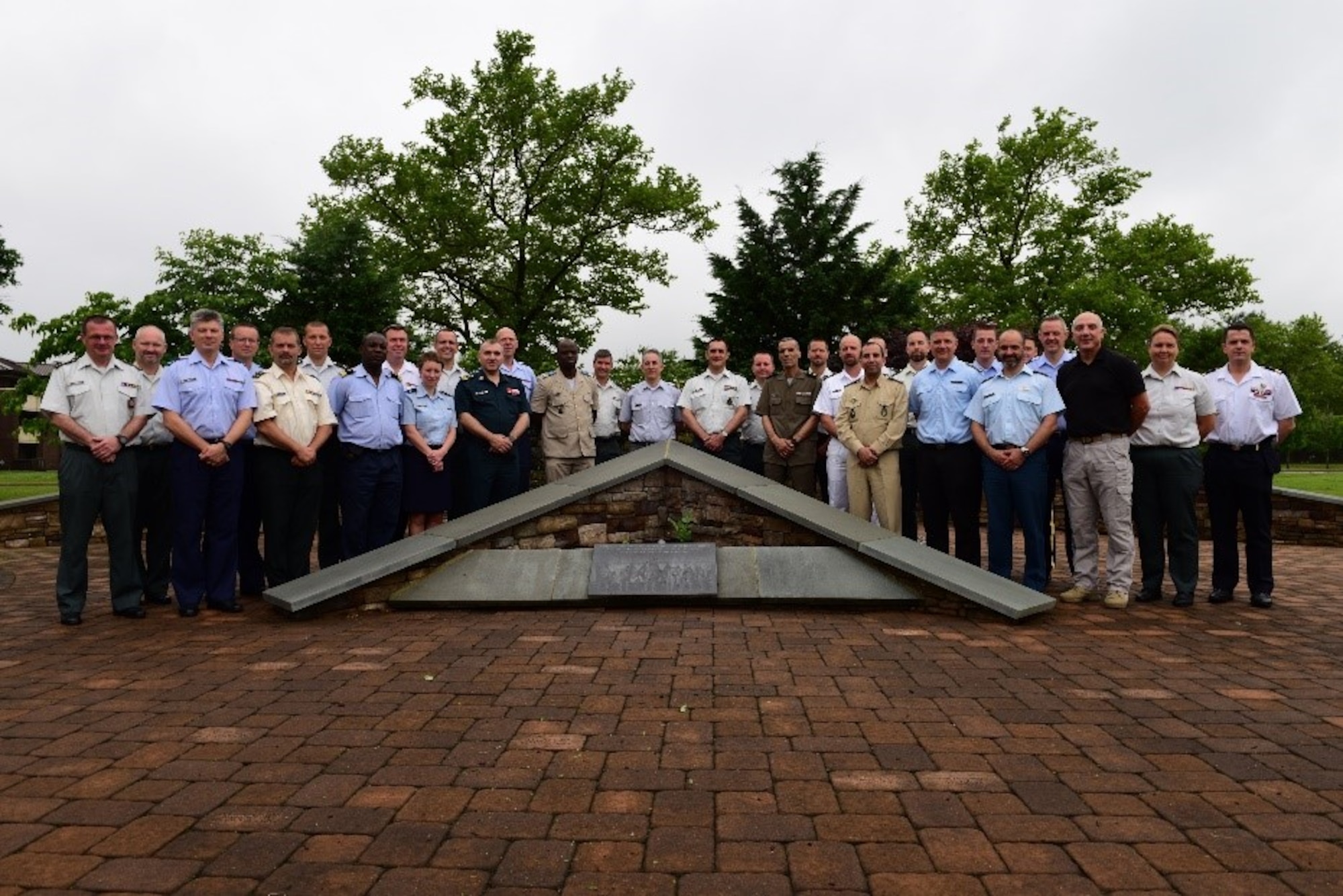 Students from the Royal Belgian Military Academy pose behind the Air Advisor Memorial at Joint Base McGuire-Dix-Lakehurst, New Jersey, June 20, 2019. The Air Advisor Academy was the first stop for the students of a three-part tour of the Joint Base. (U.S. Air Force photo by Airman 1st Class Shay Stuart)