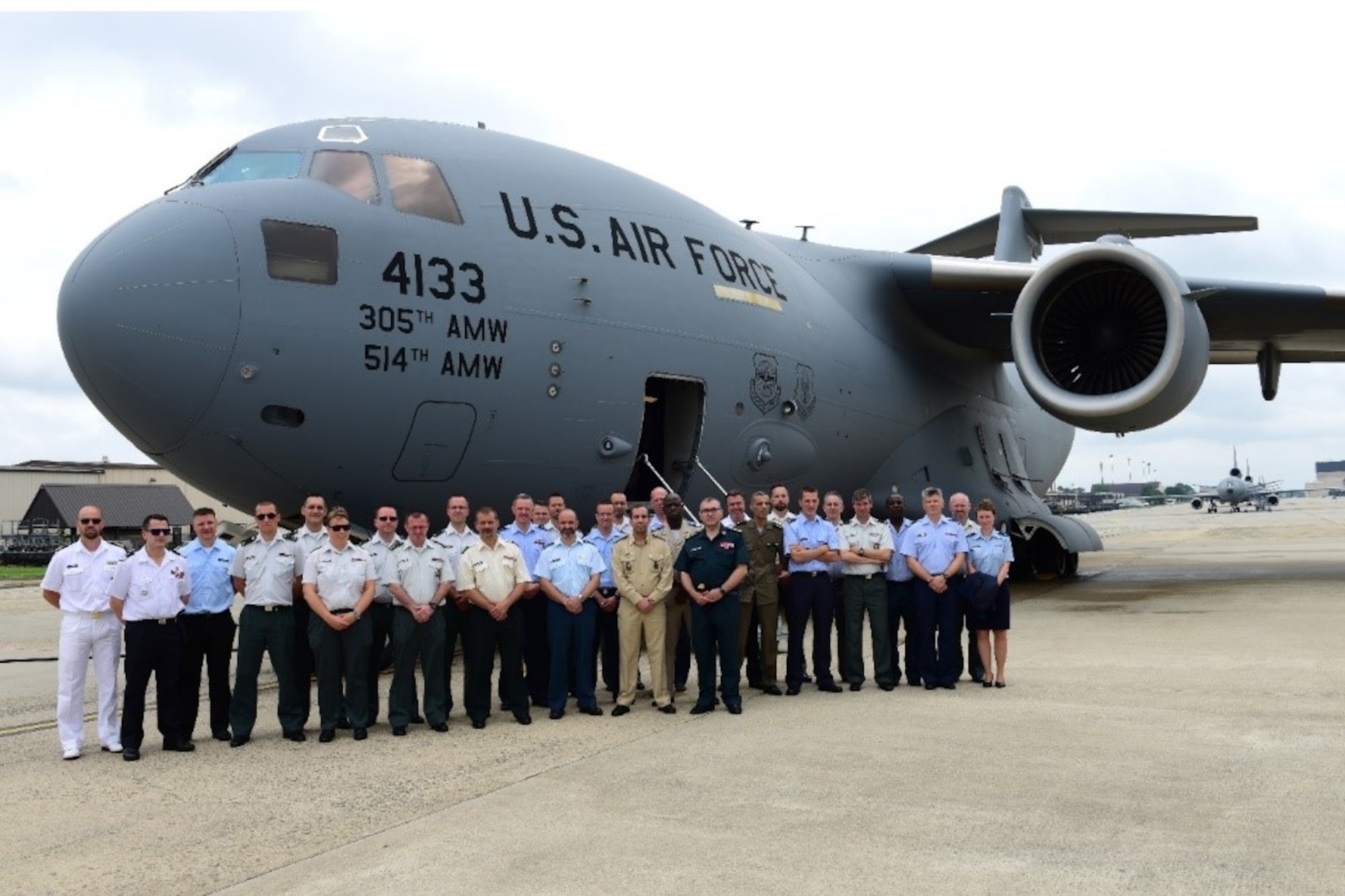 Belgium Royal Military Academy students stand on the flight line alongside a C-17 Globemaster III on Joint Base McGuire-Dix-Lakehurst, New Jersey, June 20, 2019.  Students were able to tour the static display and learn about the aircraft. (U.S. Air Force photo by Airman 1st Class Shay Stuart)