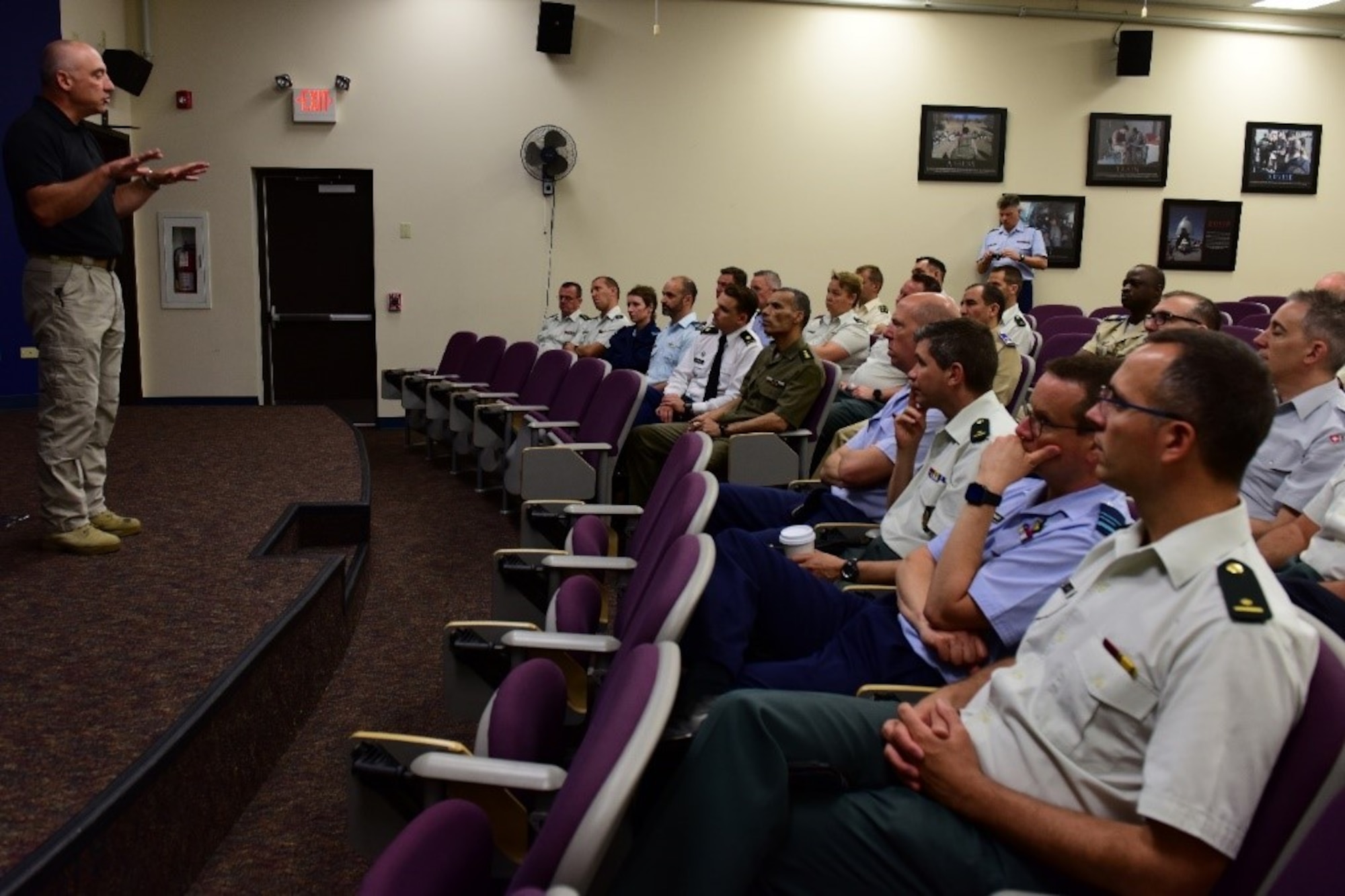 Belgium Royal Military Academy students receive a briefing from Air Advisor Academy Chief Jack Smith at Joint Base McGuire-Dix-Lakehurst, June 20, 2019. Mr. Smith explained the Air Advisory Academy’s role in helping to train military members traveling to foreign nations. (U.S. Air Force photo by Airman 1st Class Shay Stuart)