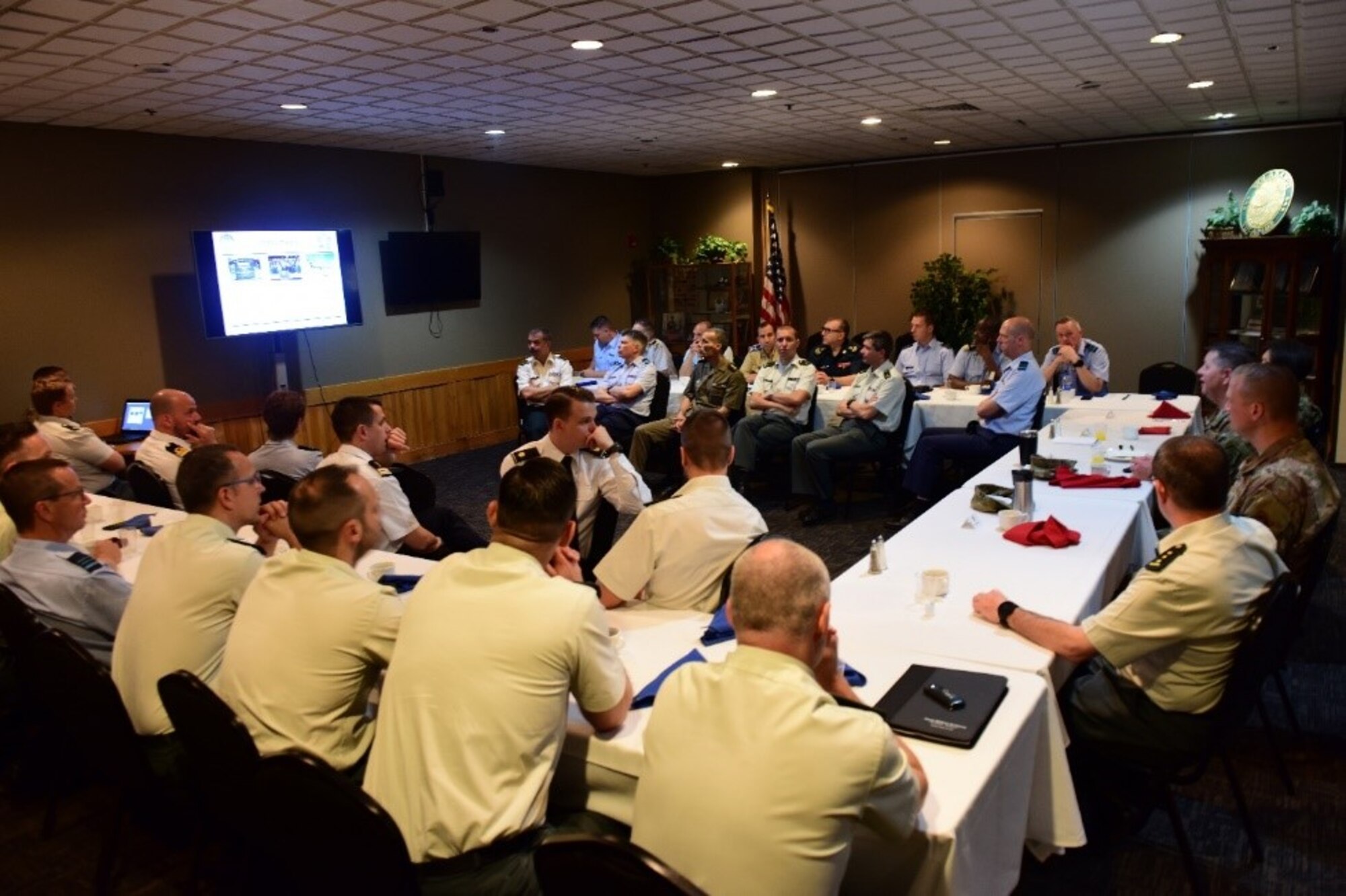 Belgium Royal Military Academy students are briefed by Joint Base MDL leadership. Colonel Neil Richardson, Colonel Jaclyn Breeden and Colonel Douglas Jackson speak about the Joint Base’s mission at Pudgy’s Daedalian Room on Joint Base McGuire-Dix-Lakehurst, New Jersey, June 20, 2019.  (U.S. Air Force photo by Airman 1st Class Shay Stuart)