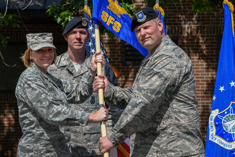PETERSON AIR FORCE BASE, Colo. – Col. Kirsten Aguilar (left), 21st Mission Support Group commander, presents the guidon to Lt. Col. Drew Gehler (right), 21st Security Forces Squadron commander, during a change of command ceremony, June 21, 2019 at Peterson Air Force Base, Colorado. The passing of the guidon represents a formal transfer of authority and responsibility from an outgoing commander to an incoming one. This ensures that the unit and its Airmen are never without leadership. (U.S. Air Force photo by Craig Denton)