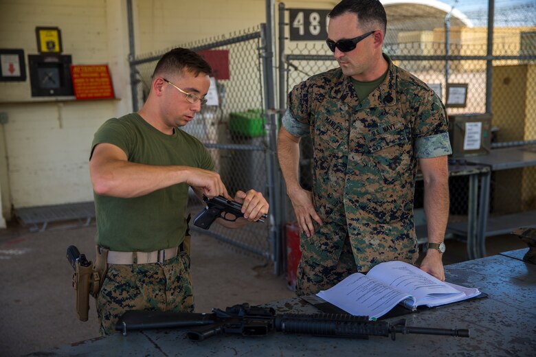 U.S. Marine Corps Lance Cpl. Tyler Huckleberry and U.S. Navy sailor HM2 David Manley, with Headquarters & Headquarters Squadron Marine Corps Air Station (MCAS) Yuma, conduct weapons training in order to qualify for the Enlisted Fleet Marine Force Warfare Specialist device on MCAS Yuma, June 11, 2019. In order to be awarded the device, a sailor must complete the Fleet Marine Force Qualification Training in order to familiarize themselves with the Marine Corps. (U.S. Marine Corps photo by Lance Cpl. John Hall)