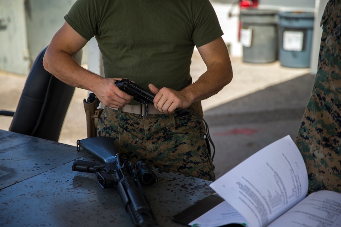 U.S. Marine Corps Lance Cpl. Tyler Huckleberry and U.S. Navy sailor HM2 David Manley, with Headquarters & Headquarters Squadron Marine Corps Air Station (MCAS) Yuma, conduct weapons training in order to qualify for the Enlisted Fleet Marine Force Warfare Specialist device on MCAS Yuma, June 11, 2019. In order to be awarded the device, a sailor must complete the Fleet Marine Force Qualification Training in order to familiarize themselves with the Marine Corps. (U.S. Marine Corps photo by Lance Cpl. John Hall)