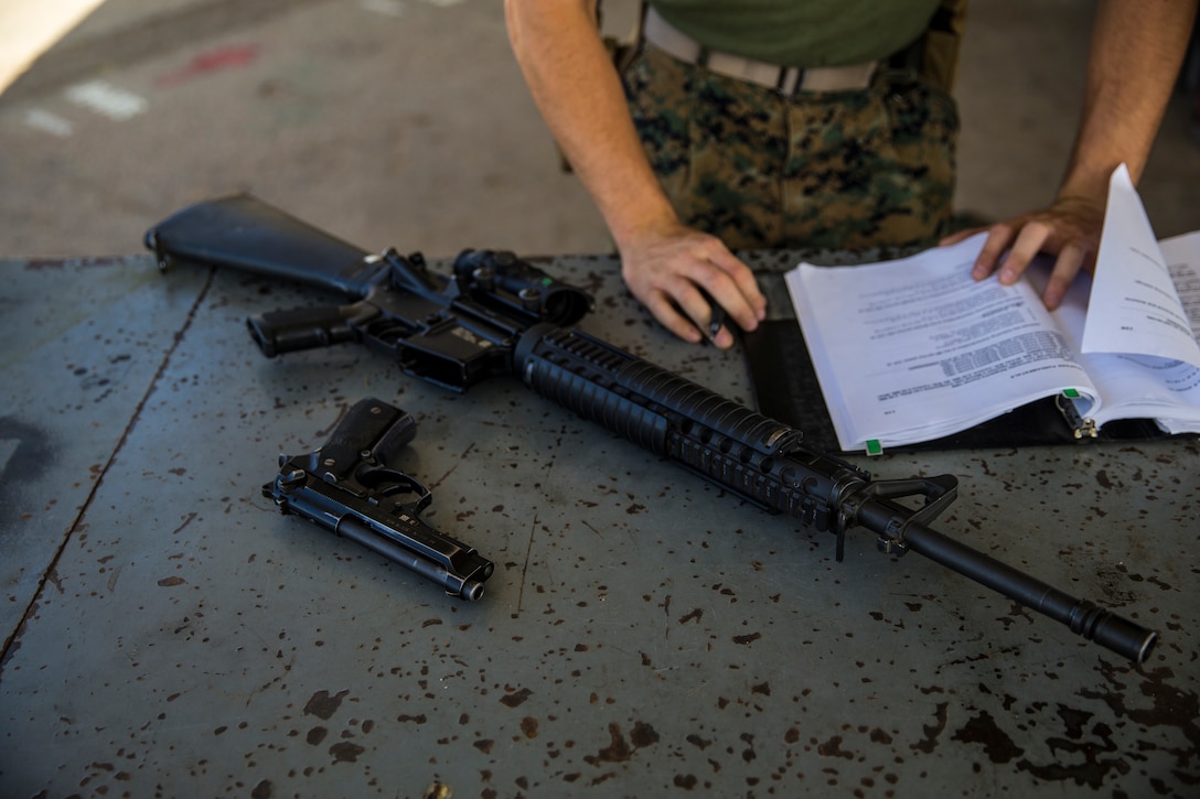 U.S. Marine Corps Lance Cpl. Tyler Huckleberry and U.S. Navy sailor HM2 David Manley, with Headquarters & Headquarters Squadron Marine Corps Air Station (MCAS) Yuma, conduct weapons training in order to qualify for the Enlisted Fleet Marine Force Warfare Specialist device on MCAS Yuma, June 11, 2019. In order to be awarded the device a sailor must complete the Fleet Marine Force Qualification Training in order to familiarize themselves with the Marine Corps. (U.S. Marine Corps photo by Lance Cpl. John Hall)