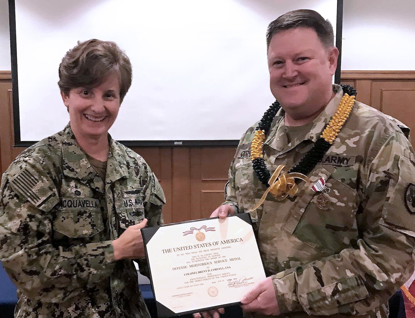 Defense Logistics Agency Indo-Pacific Commander Navy Capt. Kristin Acquavella presents an award to DLA Indo-Pacific Military Deputy Commander Army Col. Brent Coryell at Camp Humphreys, Korea.