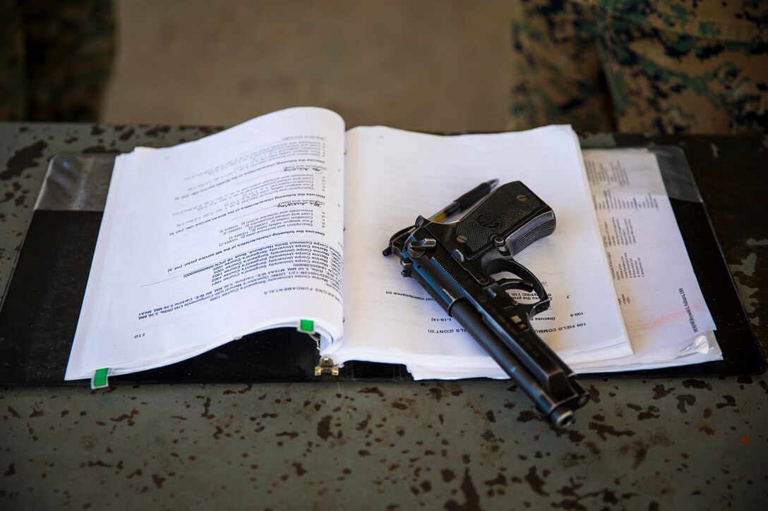 U.S. Marine Corps Lance Cpl. Tyler Huckleberry and U.S. Navy sailor HM2 Davidl Manley, with Headquarters & Headquarters Squadron Marine Corps Air Station (MCAS) Yuma, conduct weapons training in order to qualify for the Enlisted Fleet Marine Force Warfare Specialist device on MCAS Yuma, June 11, 2019. In order to be awarded the device a sailor must complete the Fleet Marine Force Qualification training in order to familiarize themselves with the Marine Corps. (U.S. Marine Corps photo by Lance Cpl. John Hall)