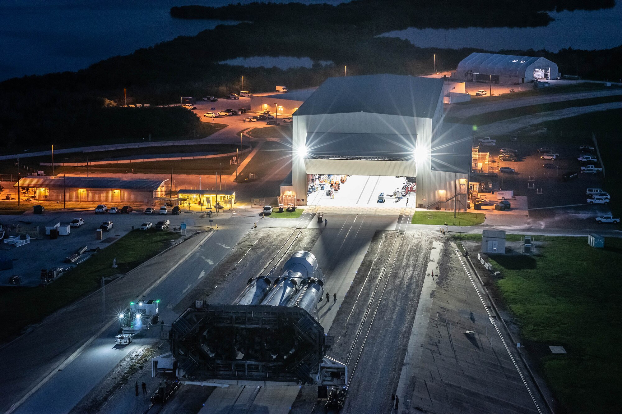 A SpaceX Falcon Heavy launch vehicle rolls out of its assembly hangar in the pre-dawn hours of June 24, 2019 for the short trip up to the historic Launch Complex-39A at NASA's Kennedy Space Center. (Photo: SpaceX)