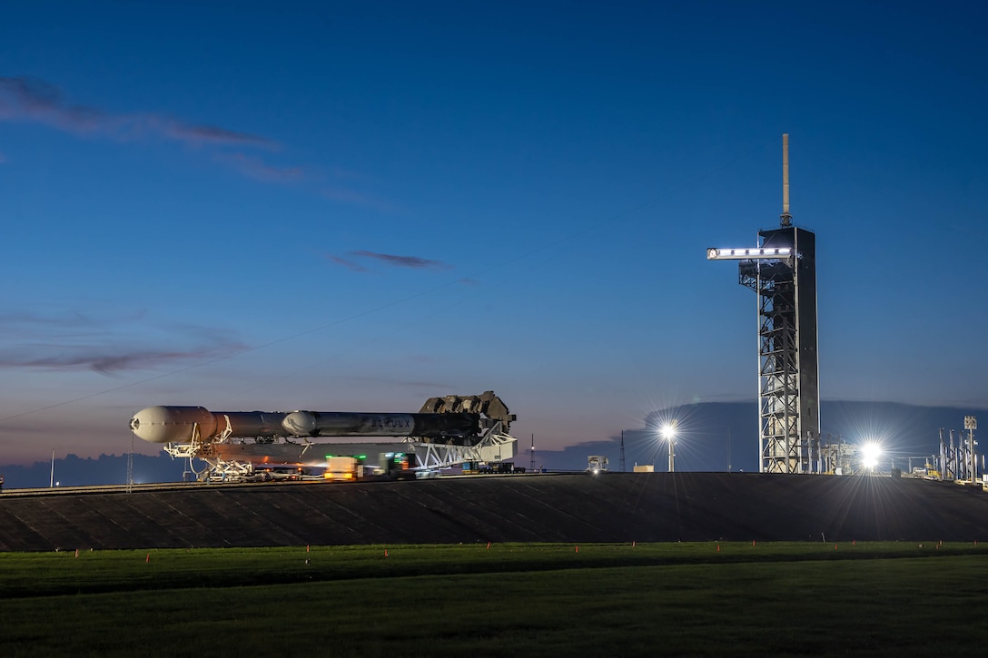 A SpaceX Falcon Heavy launch vehicle atop the Mobile Strongback Transporter, containing the Space Test Program-2 payloads encapsulated within the protective fairing, rolls up to position at Launch Complex-39A at NASA's Kennedy Space Center. (Photo: SpaceX)