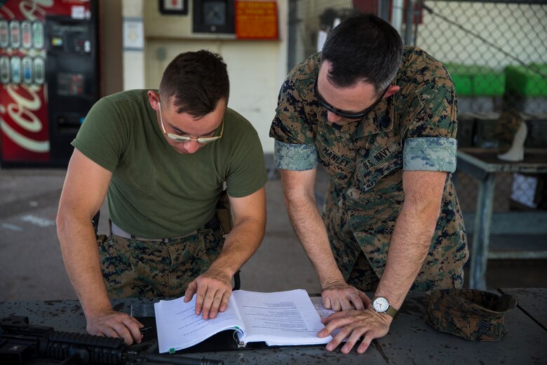 U.S. Marine Corps Lance Cpl. Tyler Huckleberry and U.S. Navy sailor HM2 David Manley, with Headquarters & Headquarters Squadron Marine Corps Air Station (MCAS) Yuma, conduct weapons training in order to qualify for the Enlisted Fleet Marine Force Warfare Specialist device on MCAS Yuma, June 11, 2019. In order to be awarded the device a sailor must complete the Fleet Marine Force Qualification Training in order to familiarize themselves with the Marine Corps. (U.S. Marine Corps photo by Lance Cpl. John Hall)