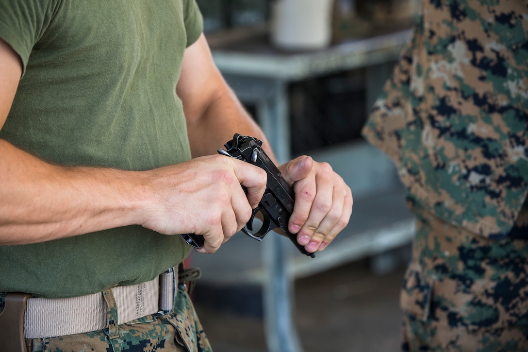 U.S. Marine Corps Lance Cpl. Tyler Huckleberry and U.S. Navy sailor HM2 David Manley, with Headquarters & Headquarters Squadron Marine Corps Air Station (MCAS) Yuma, conduct weapons training in order to qualify for the Enlisted Fleet Marine Force Warfare Specialist device on MCAS Yuma, June 11, 2019. In order to be awarded the device a sailor must complete the Fleet Marine Force Qualification Training in order to familiarize themselves with the Marine Corps. (U.S. Marine Corps photo by Sgt. Isaac D. Martinez)