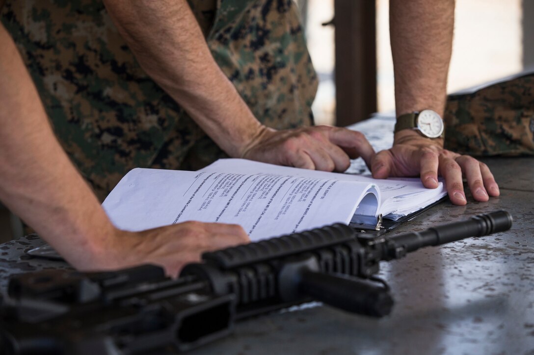 U.S. Marine Corps Lance Cpl. Tyler Huckleberry and U.S. Navy sailor HM2 David Manley, with Headquarters & Headquarters Squadron Marine Corps Air Station (MCAS) Yuma, conduct weapons training in order to qualify for the Enlisted Fleet Marine Force Warfare Specialist device on MCAS Yuma, June 11, 2019. In order to be awarded the device a sailor must complete the Fleet Marine Force Qualification Training in order to familiarize themselves with the Marine Corps. (U.S. Marine Corps photo by Sgt. Isaac D. Martinez)
