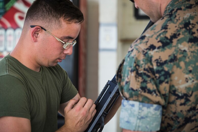 U.S. Marine Corps Lance Cpl. Tyler Huckleberry and U.S. Navy sailor HM2 Davidl Manley, with Headquarters & Headquarters Squadron Marine Corps Air Station (MCAS) Yuma, conduct weapons training in order to qualify for the Enlisted Fleet Marine Force Warfare Specialist device on MCAS Yuma, June 11, 2019. In order to be awarded the device a sailor must complete the Fleet Marine Force Qualification training in order to familiarize themselves with the Marine Corps. (U.S. Marine Corps photo by Sgt. Isaac D. Martinez)