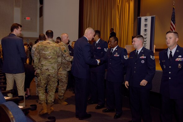 U.S. Air Force Col. Tony England, 17th Mission Support Group commander, shakes hands with graduates of the Community College of the Air Force during the Commencement Ceremony held at the theater on Goodfellow Air Force Base, June 21, 2019. The CCAF is a federally-chartered academic institution that serves the Air Force’s enlisted total force. (U.S. Air Force photo by Senior Airman Seraiah Wolf/Released)