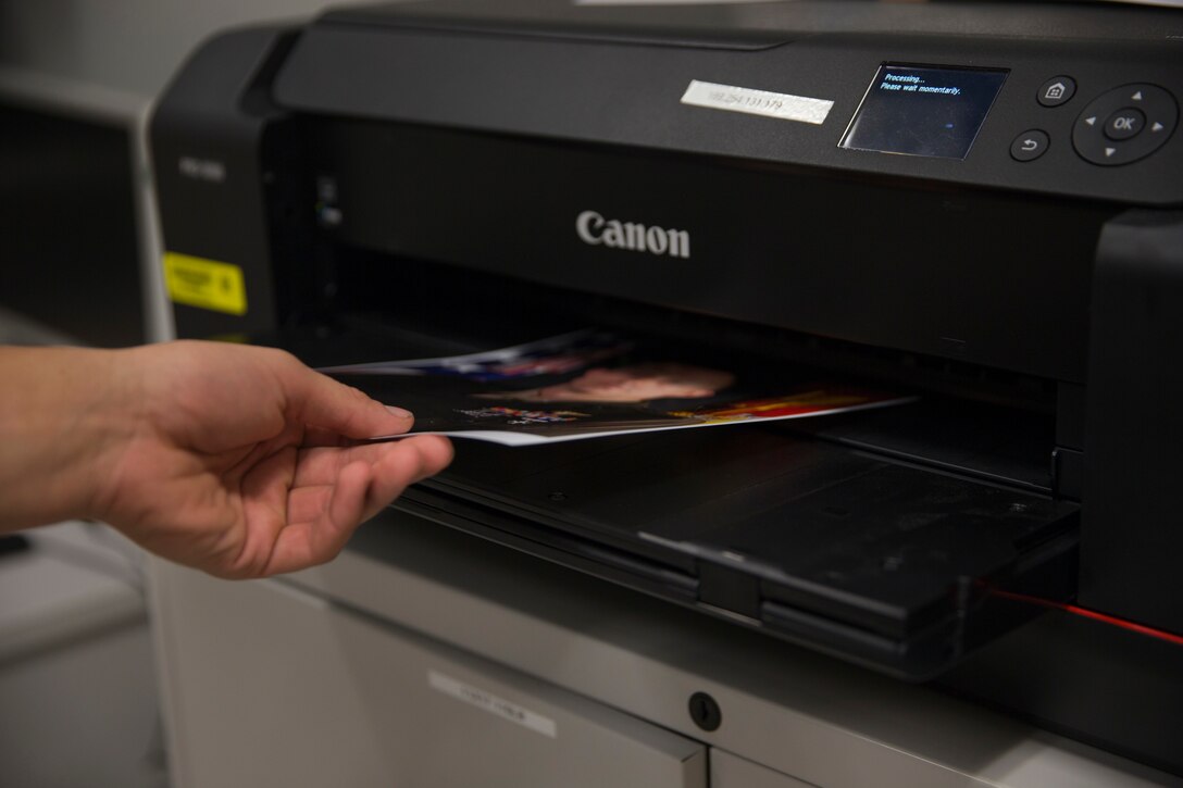 U.S. Marine Corps Lance Cpl. John Hall, a combat photographer assigned to Marine Corps Air Station (MCAS) Yuma, takes a picture in the promotion photo studio at MCAS Yuma, Ariz., June 17, 2019. As a combat photographer, Hall supports Marines aboard MCAS Yuma by taking promotion, re-enlistment, and command photos when needed. (U.S. Marine Corps photo by Sgt. Isaac D. Martinez)
