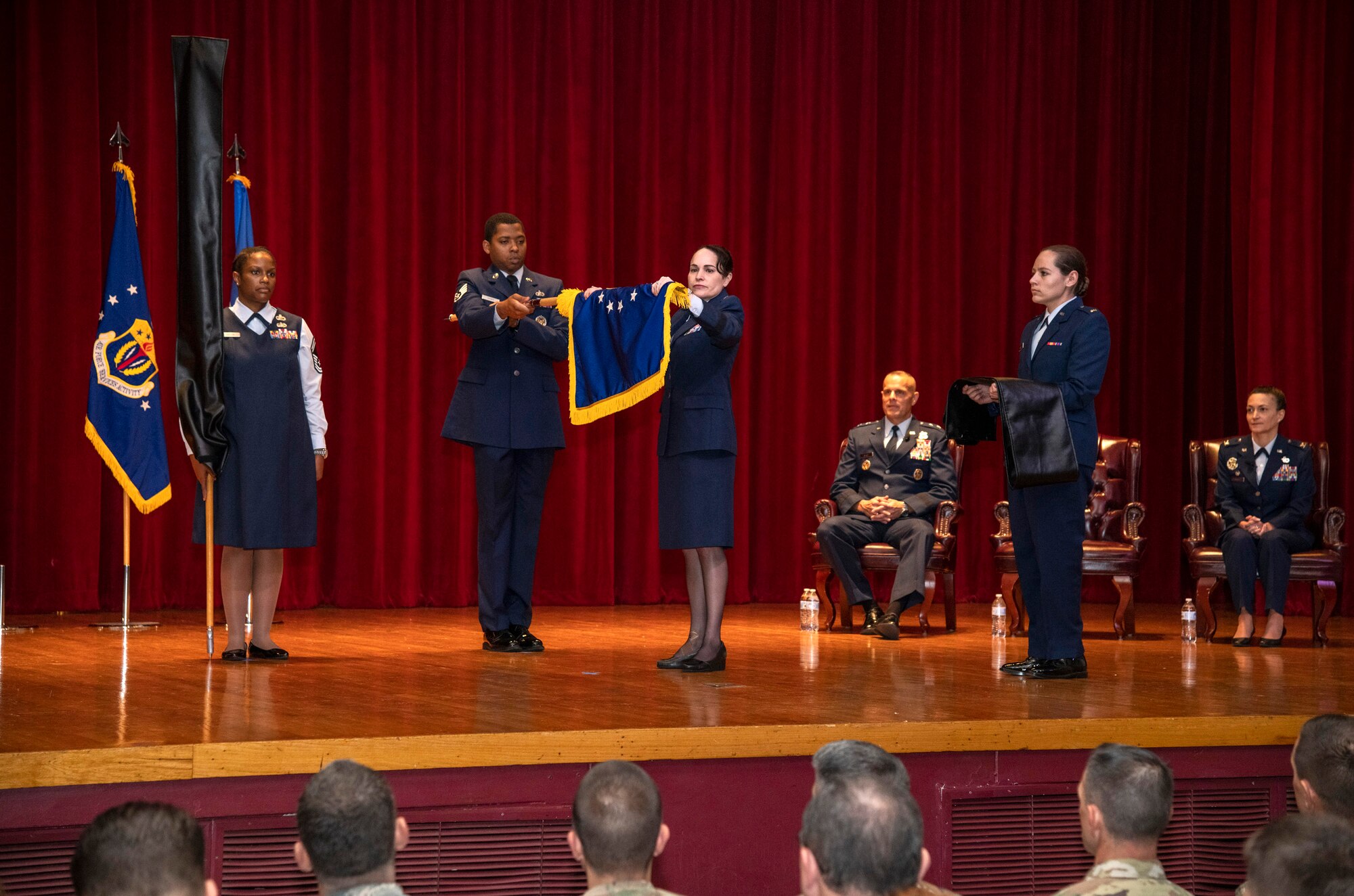 Brig. Gen. Alice Trevino, commander of the newly named Air Force Installation Contracting Center, furls her unit's old Air Force Installation Contracting Agency flag at a special ceremony June 25, 2019, on Joint Base San Antonio-Lackland, Texas. The Air Force Installation and Mission Support Center formally redesignated AFICC and the Air Force Services Center -- two of its primary subordinate units -- during a formal ceremony to bring them in line with Air Force naming conventions. (U.S. Air Force photo by Johnny Saldivar)