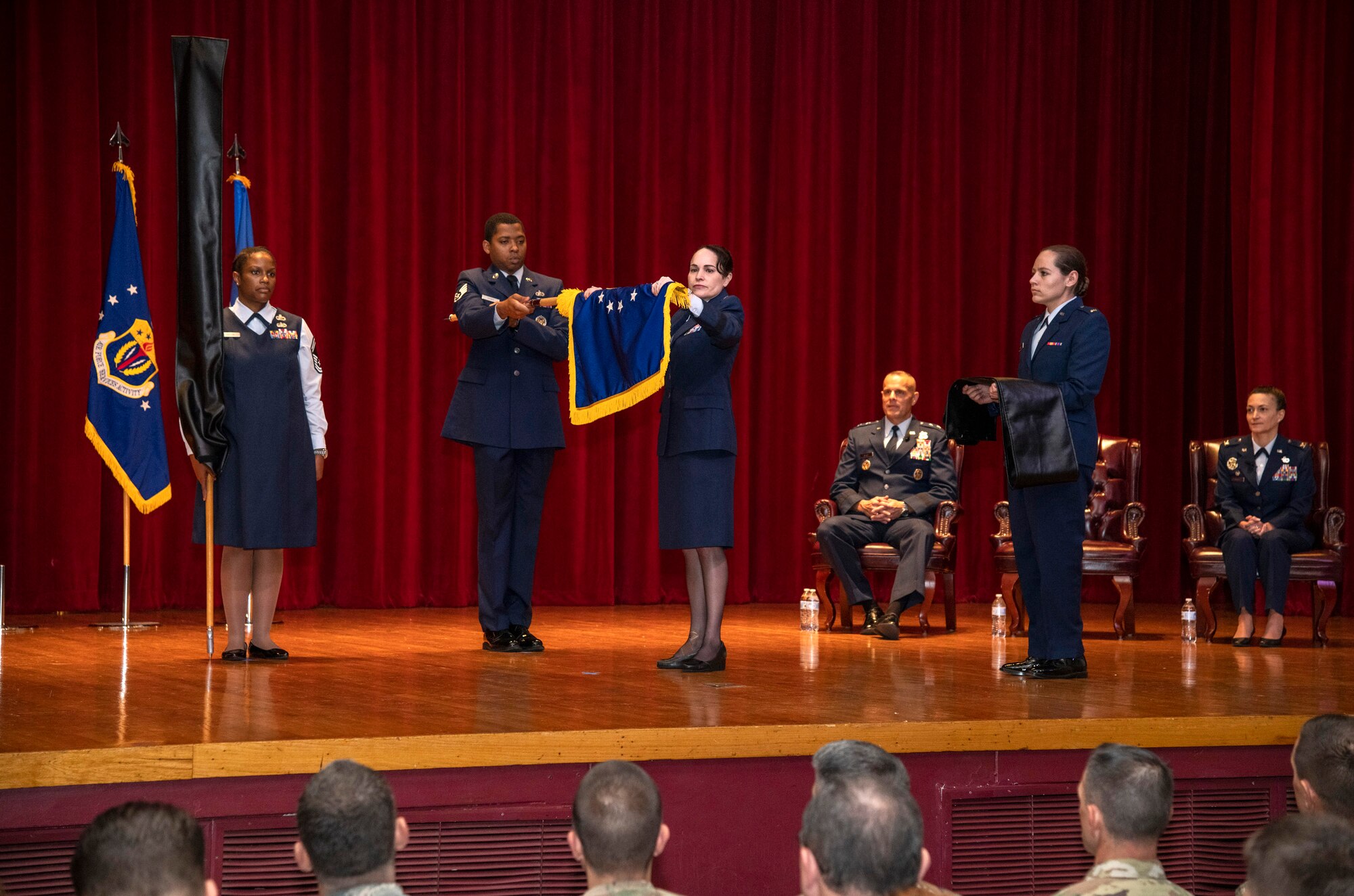 Brig. Gen. Alice Trevino, commander of the newly named Air Force Installation Contracting Center, furls her unit's old Air Force Installation Contracting Agency flag at a special ceremony June 25, 2019, on Joint Base San Antonio-Lackland, Texas. The Air Force Installation and Mission Support Center formally redesignated AFICC and the Air Force Services Center -- two of its primary subordinate units -- during a formal ceremony to bring them in line with Air Force naming conventions. (U.S. Air Force photo by Johnny Saldivar)