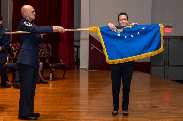 Col. Donna Turner, commander of the newly named Air Force Services Center, unfurls her unit's new flag at a special ceremony June 25, 2019, on Joint Base San Antonio-Lackland, Texas. The Air Force Installation and Mission Support Center formally redesignated AFSVC and the Air Force Installation Contracting Center-- two of its primary subordinate units -- to bring them in line with Air Force naming conventions. (U.S. Air Force photo by Johnny Saldivar)