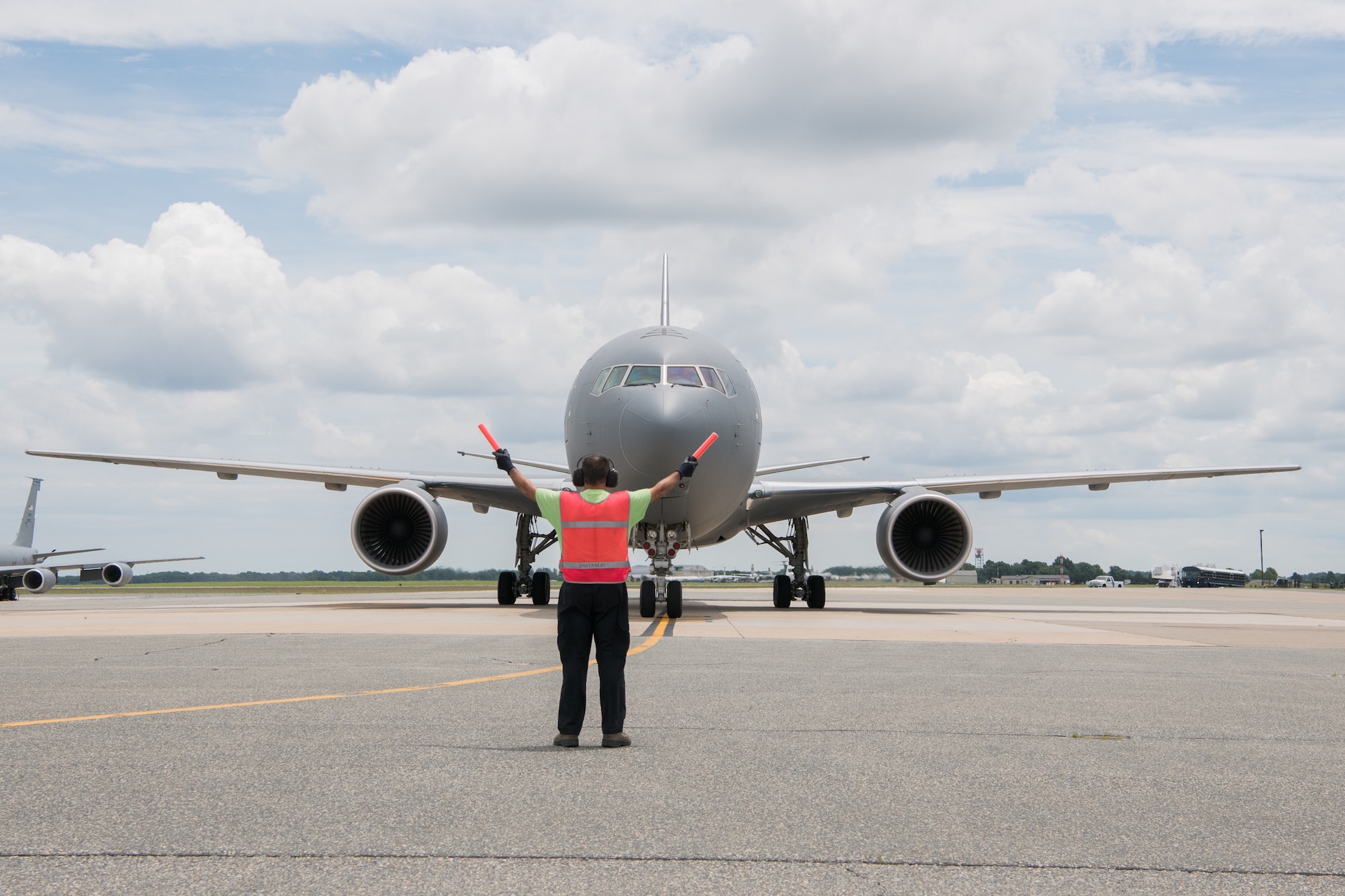 A KC-46A Pegasus belonging to the 344th Air Refueling Squadron is marshalled onto a parking spot after landing June 25, 2019, at Dover Air Force Base, Del. This was the first time a KC-46A has visited Dover AFB. (U.S. Air Force Photo by Mauricio Campino)