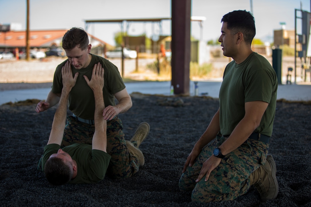 U.S. Marines stationed at Marine Corps Air Station (MCAS) Yuma, practice Marine Corps Martial Arts Program (MCMAP) techniques at MCAS Yuma, Ariz., June 18, 2019. MCMAP is a combat system developed by the United Stated Marine Corps to combine martial arts techniques with morale and team-building functions and instructions in the warrior ethos that Marines should embody. (U.S. Marine Corps photo by Lance Cpl. Hall)