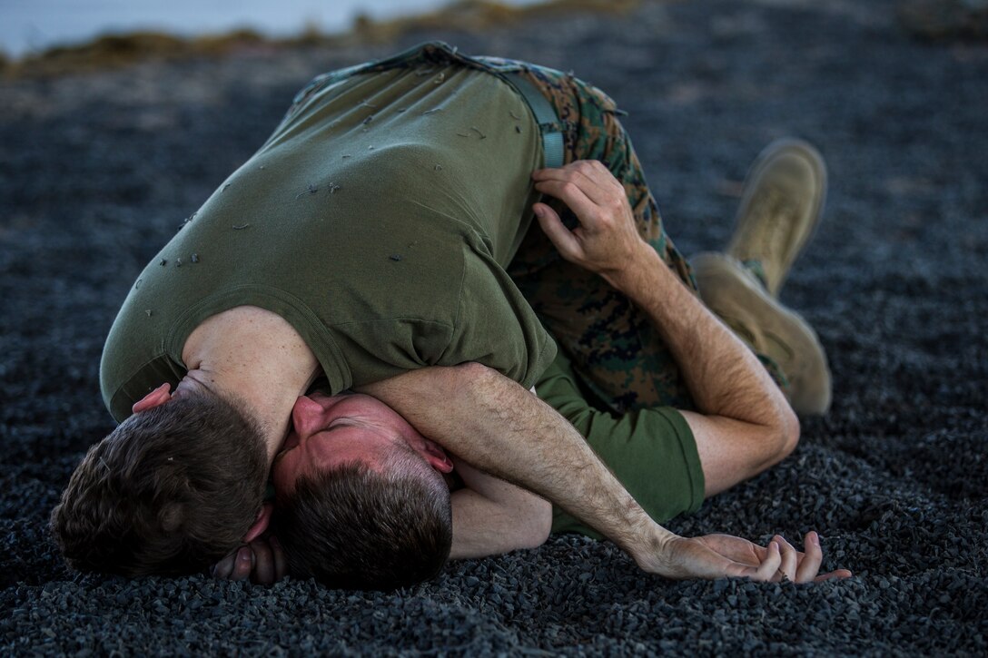 U.S. Marines stationed at Marine Corps Air Station (MCAS) Yuma, practice Marine Corps Martial Arts Program (MCMAP) techniques at MCAS Yuma, Ariz., June 18, 2019. MCMAP is a combat system developed by the United Stated Marine Corps to combine martial arts techniques with morale and team-building functions and instructions in the warrior ethos that Marines should embody. (U.S. Marine Corps photo by Lance Cpl. Hall)